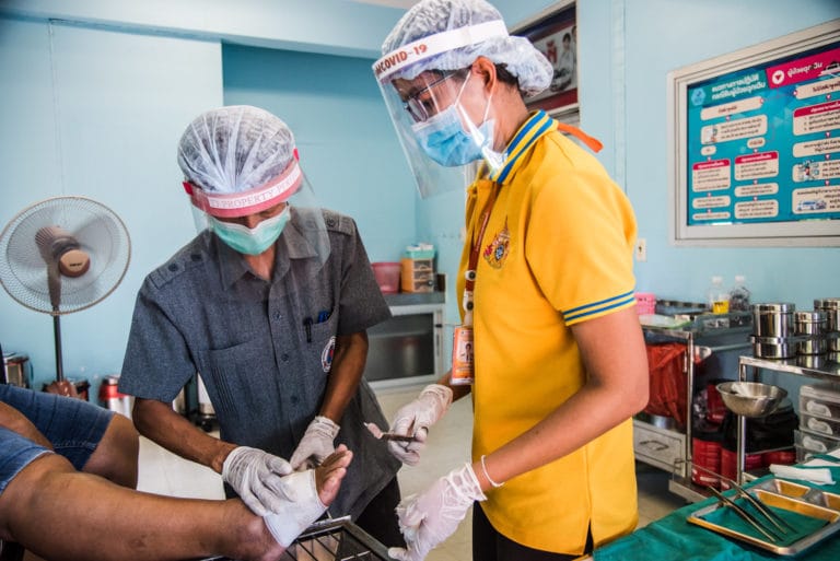 a-trained-vhv-in-grey-safari-top-working-to-support-nurse-at-koo-bang-luang-district-primary-care-centre-pathum-thani